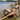 Woman sunbathing in a 13 Color Crochet Micro Bikini Sunbathing by a beach, showcasing a vibrant knit design.