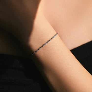 Elegant Dainty Silver Bracelet on a wrist, showcasing its fine chain design and 925 metal stamp. Perfect for women.